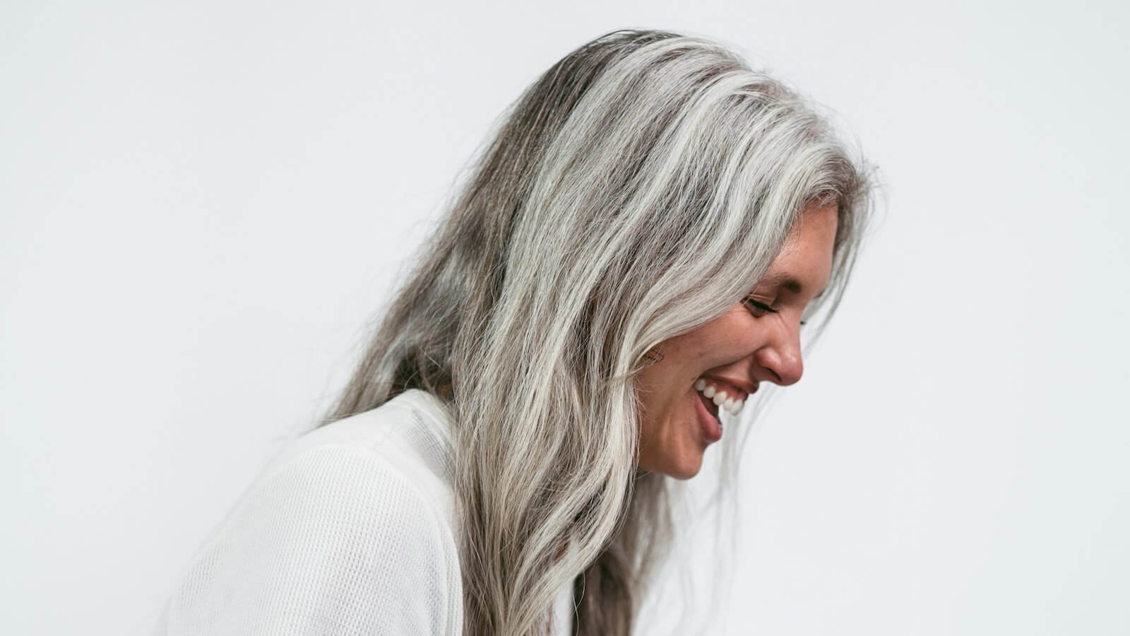 Woman with long gray hair laughing